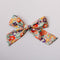 Colorful floral bow on a light gray background