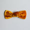 A hand-dyed velvet bow in a caramel color, displayed on a white background.