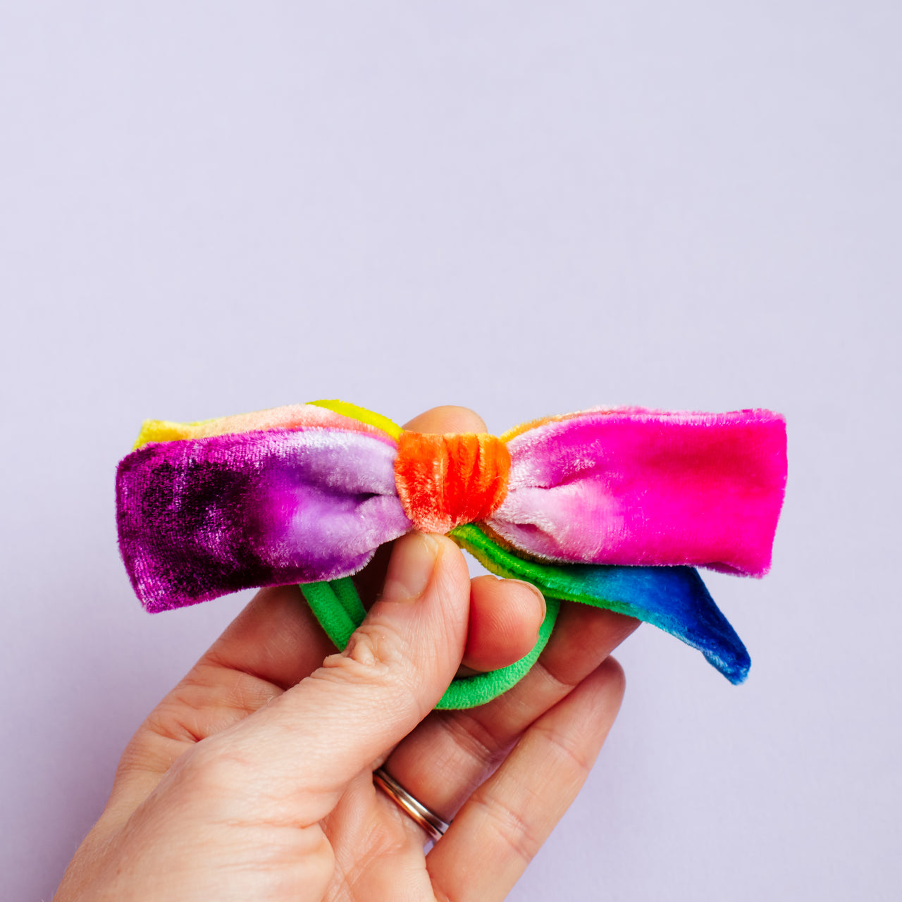 bright rainbow bow on seamless hair tie