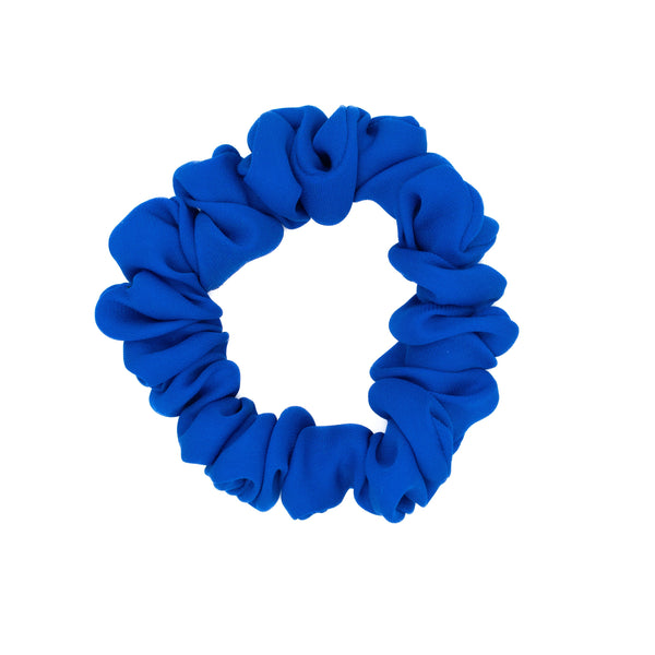 Royal blue silk scrunchie on a white background